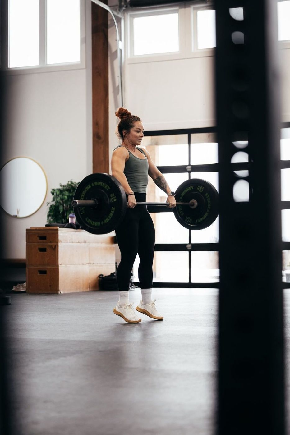 Ashley lifting a barbell in the gym