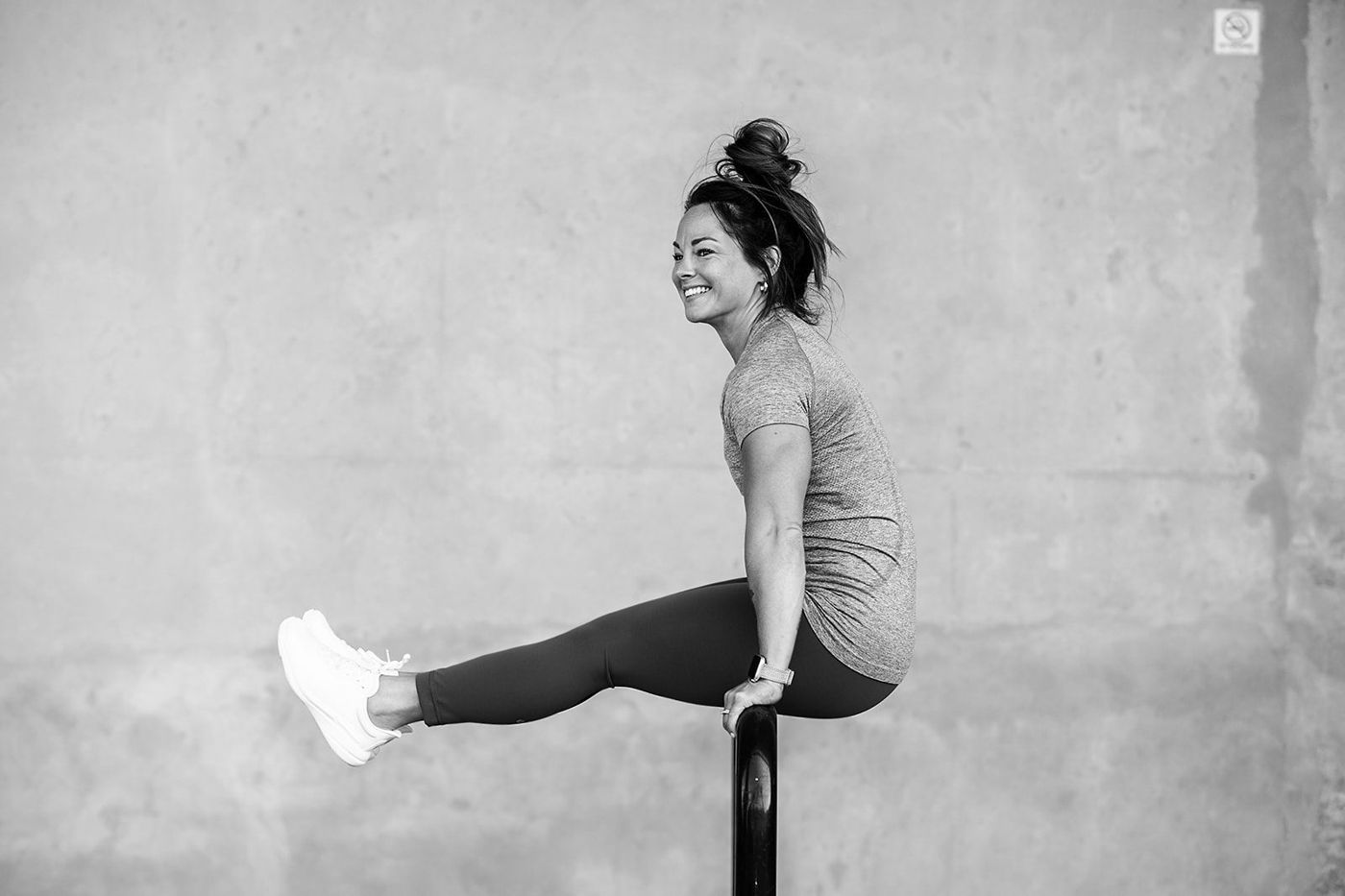 Ashley holding an L-sit, black and white