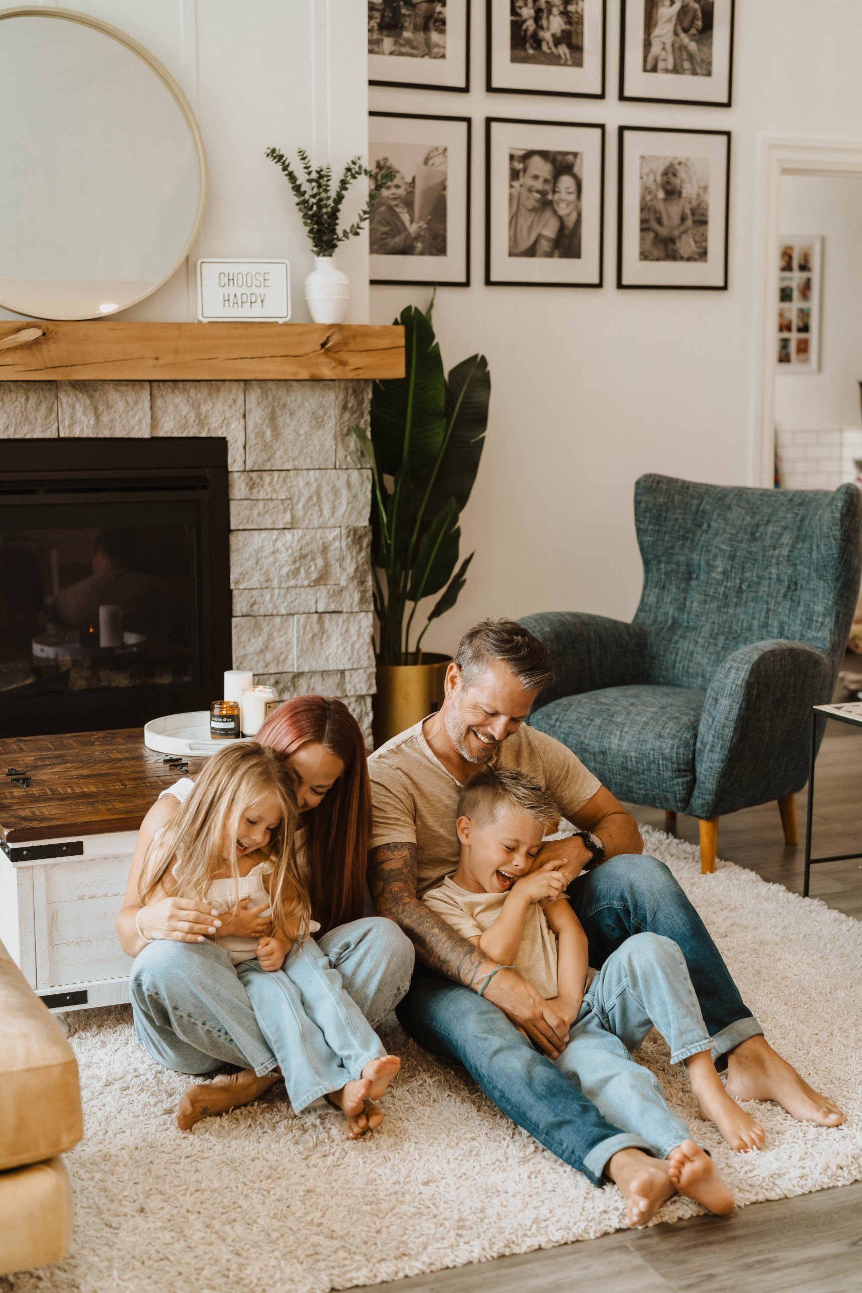 Ashley and her family laughing together on the living room floor